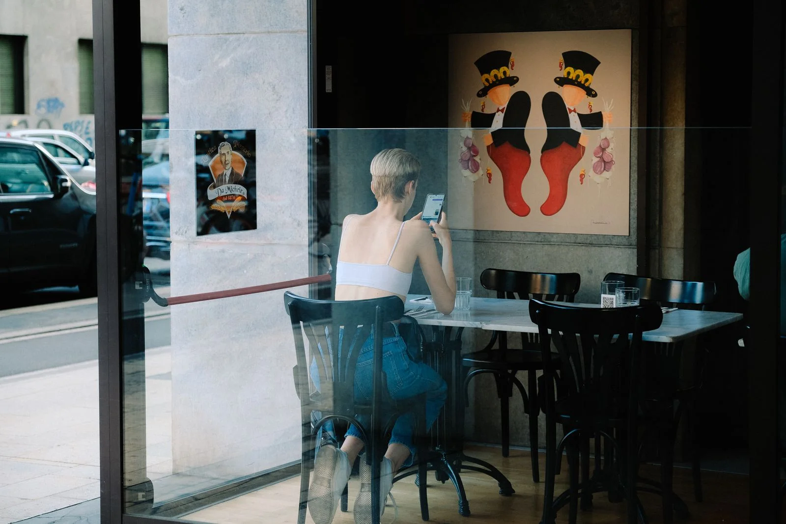 A person using a smartphone while seated in a café