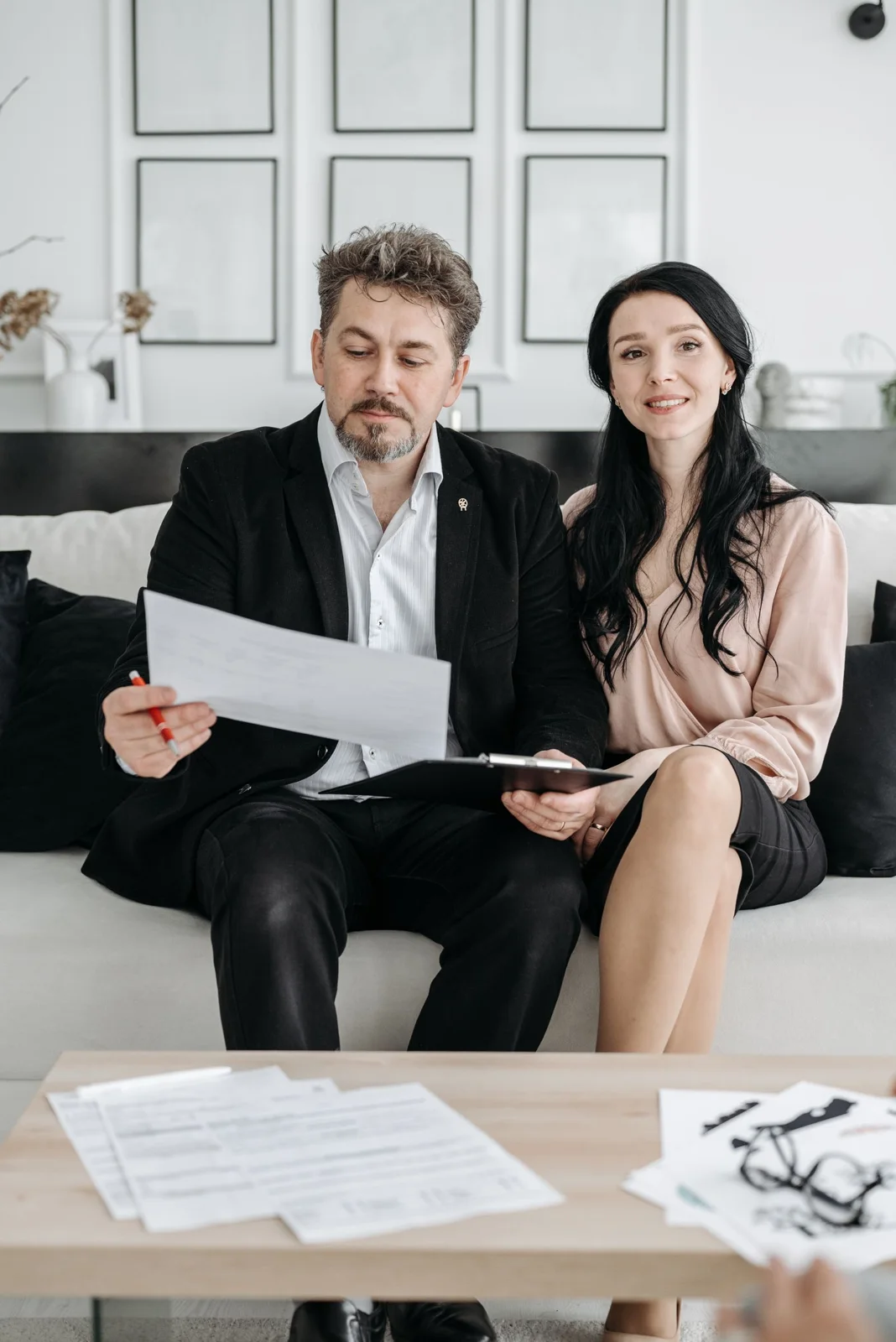 Two people discussing documents while seated together